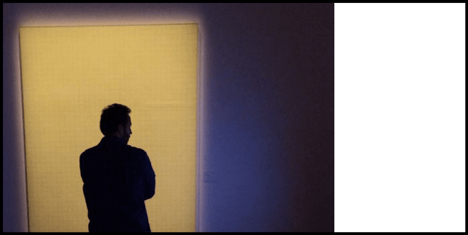 Silhouette of Vinson Milligan standing with arms folded at a Swedish museum exhibit